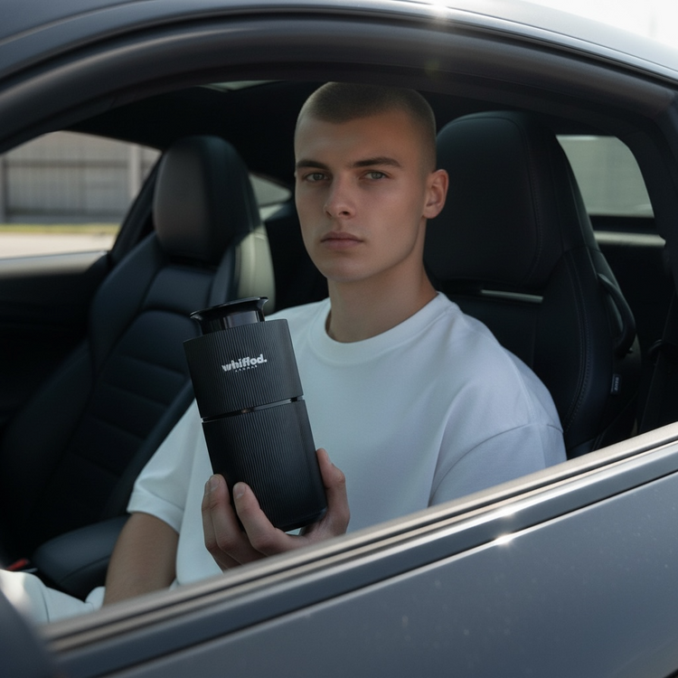 a man holding a mobile one envy diffuser